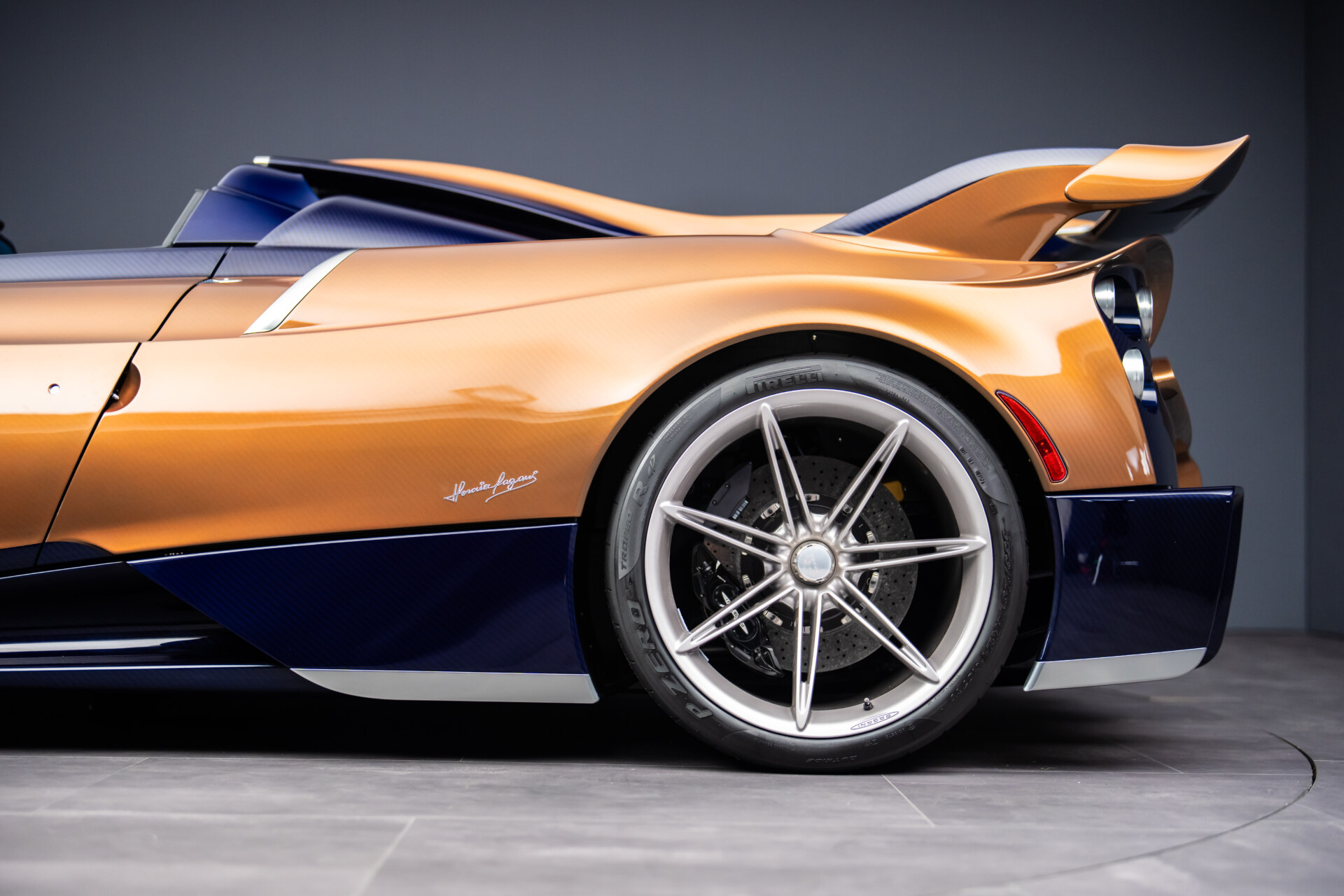 Vista lateral del Pagani Huayra 70 Derecho en color naranja y azul.