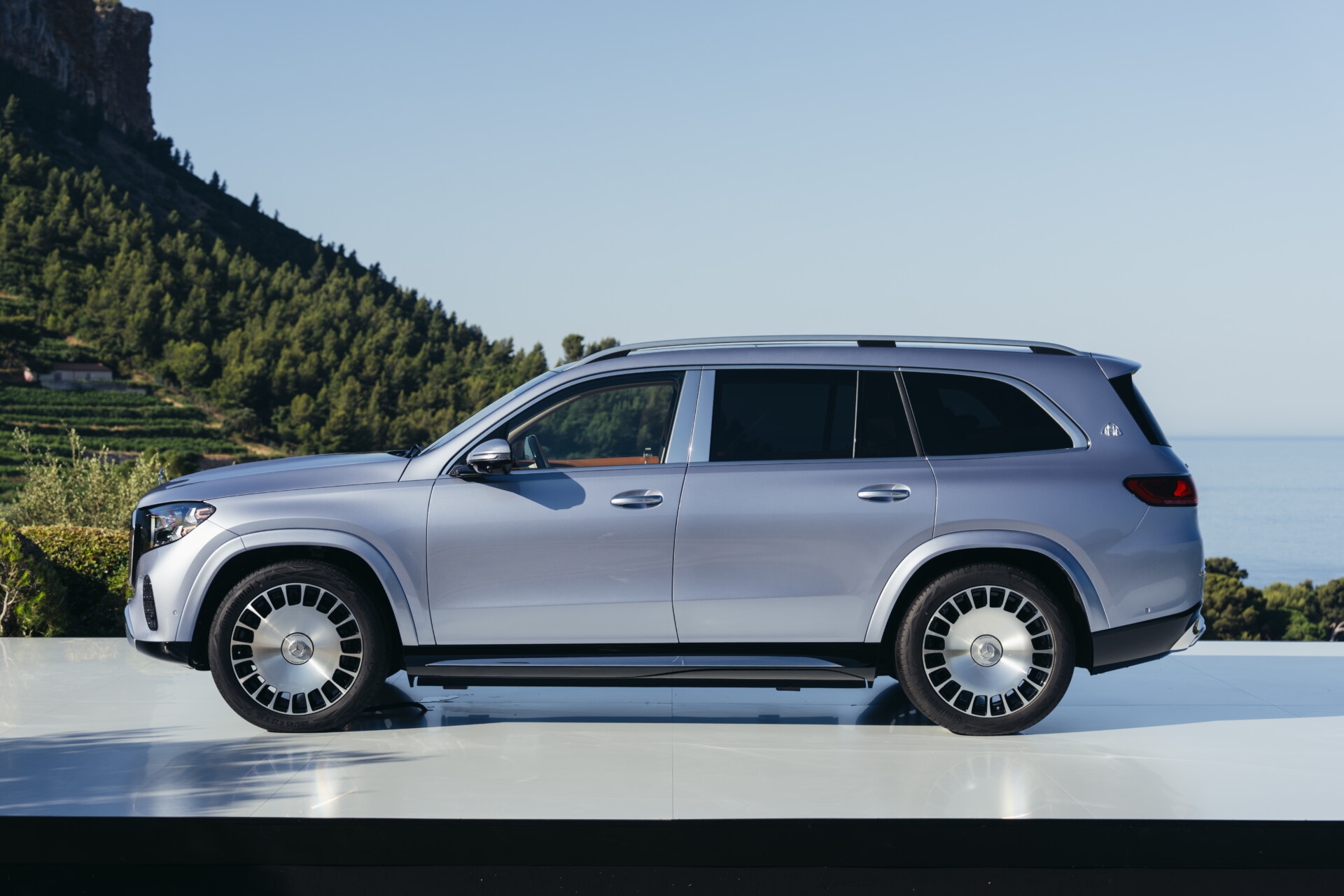 Vista lateral del Mercedes-Maybach GLS 680 2027 en un entorno natural