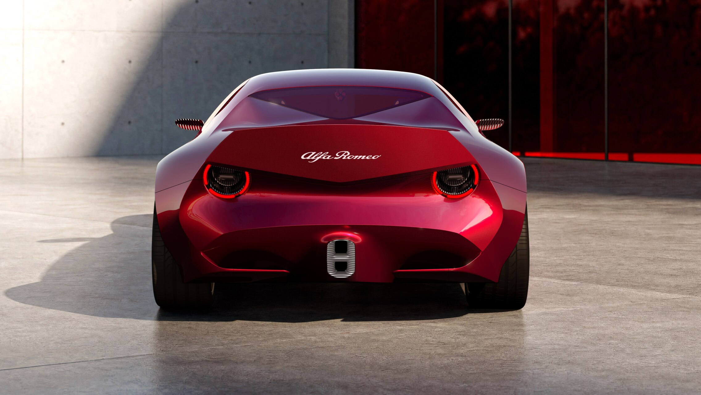 Vista trasera de un prototipo Alfa Romeo rojo en un espacio interior iluminado